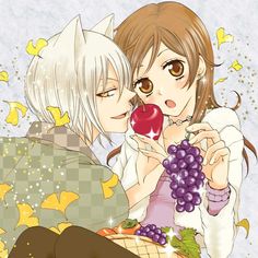 two anime characters are kissing while holding grapes and an apple in front of their face