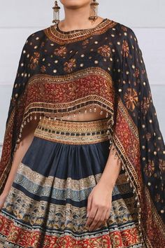 Black chanderi lehenga with geometric and floral printed motifs. Paired with printed cape attached blouse.
Component: 2
Printed
Neckline: Round
Sleeve Length: Three quarter
Fabric: Lehenga: Chanderi, Blouse: Silk
Color: Black
Tassel border
Attached cape - Aza Fashions Cape Lehenga, Cape Set, Black Lehenga, Tarun Tahiliani, Stylish Party Dresses, Chaniya Choli, Set For Women, Indian Outfits, Black Print