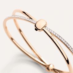 Simple yet deeply symbolic, the Pomellato Together Collection eloquently expresses the enigma of love in its many forms. The bracelet captures the connections that bind us together, with the distinctive double bands of gold united by a link, in smooth rose gold and set with white diamonds. MATERIAL: 18k Rose Gold / 18k White Rhodium-Plated Rose Gold STONE: 115 Diamonds STONE WEIGHT: 0.9 ct STONE SHAPE: Round Brilliant-Cut Diamond- The name derives from the Greek ‘adamas’, which means unbreakable Chic Rose Gold Bracelet For Formal Occasions, Chic Formal Rose Gold Bracelet, Elegant Double Band Gold Bracelets, Elegant Double Band Adjustable Bracelets, Elegant Double Band Formal Bracelets, Elegant Double Band Bracelets For Formal Occasions, Elegant Adjustable Double Band Bracelets, Chic Rose Gold Bangle For Formal Occasions, Elegant Double Band Bracelet Jewelry