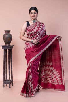 Ideal festive wear, this cherry maroon color saree has been specially designed with a discharge paint style. A sober saree for those who don't like loud fashion. COLOUR: Cherry Maroon and White CRAFT: Hand block printing  DIMENSIONS: Saree length 6.5 Mts., Saree width 1.14 Mts. Blouse piece inclusive. NET QUANTITY: 1 pc saree PATTERN: Leaf PRODUCT MATERIAL: Handwoven Pure Mulberry Silk saree PRODUCT TYPE: Saree with Blouse piece WEIGHT: 350 g WASH INSTRUCTIONS: Dry cleaning is recommended for this product. Iron inside out. Do not bleach and expose this product to excessive heat and sunlight for long. Cheap Red Art Silk Saree, Luxury Cotton Silk Saree, Elegant Style, Luxury Cotton Saree For Festive Occasions, Luxury Cotton Saree For Festive Season, Cheap Embroidered Cotton Saree, Luxury Cotton Saree With Traditional Patterns, Luxury Cotton Silk Designer Saree, Luxury Cotton Silk Festive Saree, Cheap Cotton Saree With Self Design