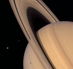 saturn and its rings in the sky with two planets behind it, as seen from earth