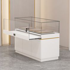 a bird cage sitting on top of a white counter next to a wall with gold trim