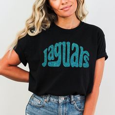 GO JAGUARS Jacksonville Jaguar Football! Go Jags! ◆ SIZE AND COLOR We offer a wide variety of shirt styles Select Size/Style and Color from the drop-down menus ◆ CARE INSTRUCTION Turn garment inside out Machine wash cold with similar colors Use mild detergent No Bleach Tumble dry low Do not iron If you have a design of your own in mind, send us a message!  We are always looking for fun new things! Thank you so much for visiting our shop. Trendy Black Tops For Game Day, Trendy Relaxed Fit Fan Merchandise Shirt, Relaxed Fit Graphic Tee For Game Day, Graphic Tee With Relaxed Fit For Game Day, Relaxed Fit Fan Apparel Tops For Game Day, Trendy Crew Neck Top For Game Day, Trendy Short Sleeve Top For Game Day, Game Day Relaxed Fit Shirt With Letter Print, Game Day Letter Print Relaxed Fit Shirt