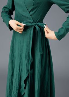 "★★ FEATURES * Pure linen fabric * Two side seam pockets * Wrap dress with belt on waist * V neckline * Midi length * Perfect for Spring, Summer, Autumn * Wash by hand or machine with cold water ★★ The model is 165 cm (5′ 5″) tall with a 80 cm (31.5\") bust, 66 cm (26\") waist. She is wearing the brown linen skirt in size XS. ★★ Bespoke Order Service If you Request other color Request the length Your height is not between 155 cm- 172 cm Your weight is over 75 kg I can do it for you, It will need some extra fee depending on on your need. Contact with me for more detail. ★★ Get your size in Size Chart with your body measurement https://www.etsy.com/listing/794055682 ★★ Warmly Note: 1 ) : Please confirm your shipping address! If you wish to ship the item to a different address, please send me Long Green Solid Color Dress, Elegant Green Non-stretch Maxi Dress, Fitted Long Wrap Dress For Spring, Fitted Green Wrap Dress, Non-stretch Elegant Green Dress, Green Fitted Wrap Dress, Elegant Non-stretch Green Dress, Elegant Green Non-stretch Dress, Spring Long Sleeve Solid Wrap Dress