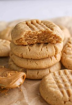 peanut butter cookies stacked on top of each other with one cookie cut in the middle