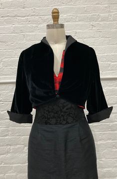 "The newest version of best-selling cropped jacket...more fitted with a pleat-front and single-button closure.  The perfect little jacket to throw on over all evening  Black velvet with silk faille collar and 3/4 sleeves with turn-back cuffs.   -hits above the waist, fitted below bust -Single button & loop closure -Rayon/silk velvet, silk faille -Fully lined in poly china silk. We are currently out of stock on this item. Estimated production time is currently 3-4 weeks. Please see instructions b Floral Ball Gown, Ball Gown Skirt, Gray Silk, Rich Fabric, Costume Outfits, Cropped Jacket, Gorgeous Fabrics, Silk Velvet, Large Bust