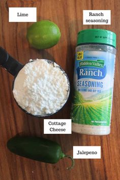 ingredients to make mexican rice on a wooden table with limes, seasoning and salt