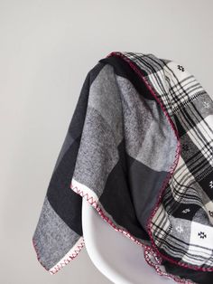 a black and white checkered blanket sitting on top of a chair