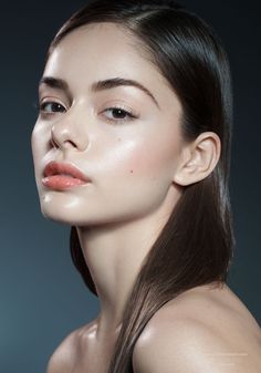 a woman with long brown hair and light makeup