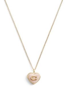 Refined chain necklace featuring a colorful pink enamel heart locket pendant adorned with COACH's signature sculpted C motif. Made from brass and enamel Includes signature COACH jewelry pouch | COACH Signature Heart Locket Pendant Necklace, 16 in Pink Jewelry With Logo Charm For Gifts, Coach Heart Charm Heart Jewelry, Coach Heart Charm Jewelry, Coach Gold Heart-shaped Jewelry, Coach Heart-shaped Gold Jewelry, Coach Heart-shaped Jewelry For Gift, Coach Elegant Heart Jewelry, Coach Elegant Heart-shaped Jewelry, Elegant Coach Heart-shaped Jewelry