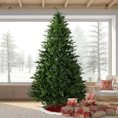 a large christmas tree sitting in the middle of a living room with presents on the floor