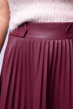 The Pelia Pleated Midi is a must-have for any wardrobe. This midi skirt features delicate pleating, an elastic back panel for a comfortable fit, and is made from luxurious burgundy vegan leather. Its A-line design flatters any figure and adds a touch of sophistication to any outfit. Hand Wash Cold Import 55% PU | 45% Viscose Fit Guide: Tabatha is 5ft 3 inches; Bust 34”, Waist 24”, Hips 36” Model is wearing a size small True to size *available at our Bandit location Chic Pleated Leather Bottoms, Chic Leather Pleated Skirt For Fall, Chic Red Pleated Skirt For Workwear, Elegant Burgundy Lined Skirt Bottoms, Elegant Burgundy Pleated Skirt, Chic Burgundy Lined Skirt, Elegant Fall Pleated Skirt With Elastic Waistband, Elegant Burgundy Skirt For Spring, Chic Burgundy Skirt For Spring