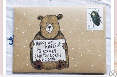 a brown bear holding a sign that says harry and the mardeline - po box 4 / 4