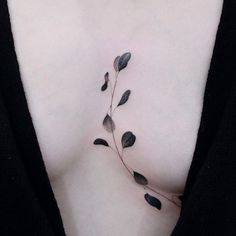 a woman's chest with leaves on it and the bottom part of her stomach