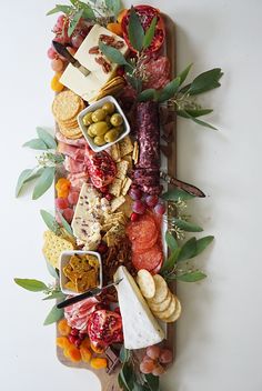 a platter filled with different types of meats and cheeses on top of each other