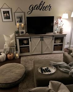 a living room filled with furniture and a flat screen tv on top of a wooden entertainment center