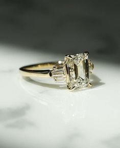 an engagement ring with three baguets on it