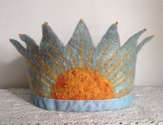 a blue and yellow crown sitting on top of a table