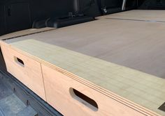 the back end of a truck with two wooden drawers