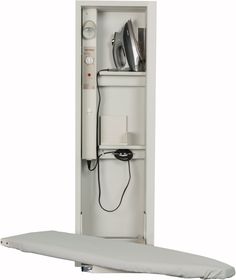 the back of a white cabinet with an electronic device in it's door and power strip attached to the wall