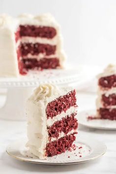 two slices of red velvet cake with white frosting