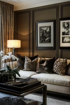 a living room filled with furniture and pictures on the wall next to a window covered in curtains