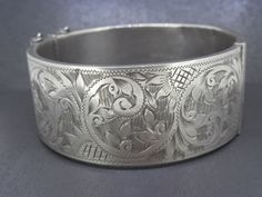 Absolutely spectacular antique buckle bracelet, very sizable!  Box clasp works great, marked B&S SILVER.  There's age related wear/patina.  Front has no dings but the back has a few, please view photos.   Weighs approx. 41.1g Measures 7" diameter Visit Ribbons Edge for more great pieces of vintage and antique jewelry! Ornate Silver Bracelet With Antique Finish, Victorian Silver Bangle, Ornate Antique Silver Bangle Bracelet, Victorian Sterling Silver Bracelet, Engraved For Formal Occasions, Vintage Engraved Antique Silver Cuff Bracelet, Buckle Bracelet, Box Clasp, Silver Bangle, Silver Bangles