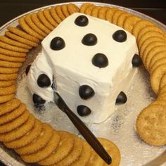 a cake made to look like a dice surrounded by crackers on a platter