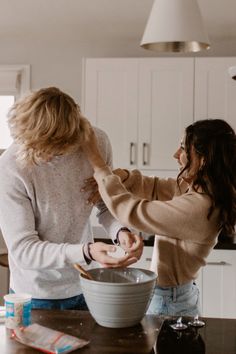 two women are in the kitchen mixing together