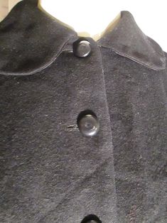 "1950's ladies petite waist clinching little jacket made in Italy. Front plastic front buttoned, big flip collar, flap back waistline with side buttoned flaps, dolman sleeves, rayon fully lined, in light wool fabric. Jacket outside is in good condition, but black rayon lining is slightly aging color changed, the buttons have a center scratch where maybe they once had a stone or something in each center . Bust about 36\"-38\", Waist 28\", Neckline about 14 1/2, and Jacket Length 19\". PRICE is $3 Vintage Winter Blazer With Covered Buttons, Vintage Collared Blazer For Formal Occasions, Vintage Blazer With Snap Buttons For Formal Occasions, Formal Vintage Blazer With Snap Buttons, Elegant Vintage Fashion Outerwear With Buttons, Vintage Formal Blazer With Snap Buttons, Vintage Black Blazer, Vintage Formal Outerwear With Button Closure, Vintage Blazer With Buttons And Lapel Collar