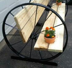 two wooden benches sitting next to each other with flower pots on them in front of the bench