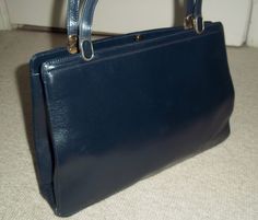 "A stunning vintage 1960's Creation Picard classic handbag in timelessly elegant Navy supple and substantial quality leather.  Size of bag approx : 12\" at widest point x 9\" high (30 cm x 23 cm) with two, short carrying handles. Bag is secured with a clasp fastener. The clasp must be fastened firmly to secure the bag. Interior has a zipped pocket and is lined in Black soft leather which is in very good and clean condition throughout. This is a vintage bag which has seen some gentle use and, other than a small and light impression to the exterior (I have zoomed in on the impression so it can be seen more readily), it is in very good condition with no major detrimental flaws." Rectangular Leather Bag For Weddings, Rectangular Leather Bag For Wedding, Rectangular Leather Wedding Bag, Rectangular Leather Wedding Bags, Retro Formal Satchel With Top Carry Handle, Classic Handbags, Top Handle Bags, Wedding Bag, Vintage Bag