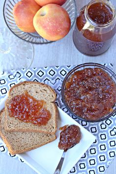 two slices of bread on a plate with jam and peaches