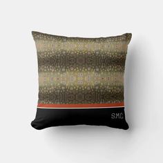 a brown and black pillow sitting on top of a white wall with an orange stripe