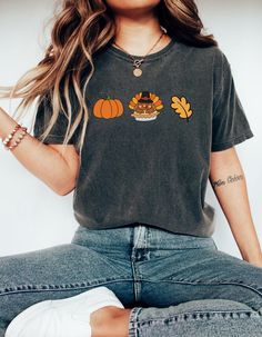 A cute Thanksgiving T-shirt perfect for the fall season. Features pumpkins, turkeys, and fall leaves. Ideal for those looking for holiday apparel to celebrate Thanksgiving. The unisex garment-dyed Comfort Colors 1717 tee offers long-lasting comfort and a relaxed fit suitable for casual or semi-formal occasions. Product features - Available in multiple sizes from S to 4XL - Double-needle stitching for durability - Ethically made with 100% US cotton - Pre-shrunk fabric for consistent fit - Available in 58 colors Care instructions - Machine wash: cold (max 30C or 90F) - Do not bleach - Tumble dry: low heat - Iron, steam or dry: low heat - Do not dryclean Thanksgiving Parfait, Leaves Shirt, Cute Fall Shirt, Turkey Shirts, Holiday Apparel, Thanksgiving Shirt, Holiday Shirt, Pumpkin Shirt, Color Care