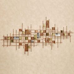 an aerial view of a wall sculpture made out of metal rods and wood planks