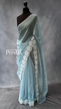 Powder blue jute organza saree with scallop borders. The saree is complimented with off-white embroidery and sequins work. Blouse: off-white semi dupion silk [Unstitched]. Please note there may be slight colour variations due to lighting. please send us a message if you want blouse material separated  and need pico ( no extra charge) Blue Organza Saree, Blue Sari, Blue Organza, Long Kurti, Long Kurti Designs, Dupion Silk, Organza Saree, Blouse Material, White Embroidery