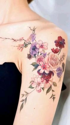 a woman's shoulder with flowers on it