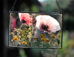 an image of some flowers hanging from a chain