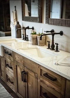 two sinks and mirrors in a bathroom with wooden cabinetry on both sides, one is white