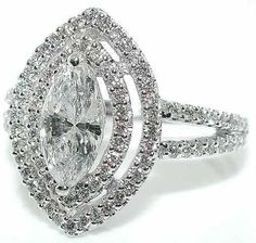 an oval shaped diamond ring with double halos