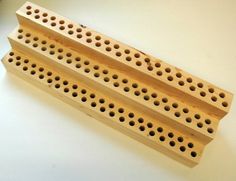 two wooden pegs with holes in them