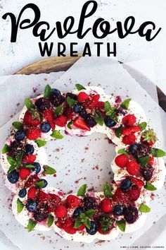 a cake with berries and whipped cream on top