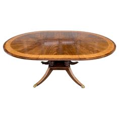 an oval dining table with two leaves on each end