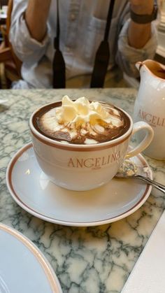 a cup of hot chocolate with whipped cream on top