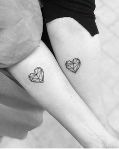 two people with matching tattoos on their legs, one has a heart and the other has a diamond