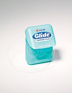 a close up of a container of gum on a white surface