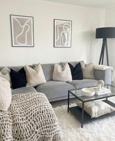 a living room filled with furniture and pillows on top of a white carpeted floor