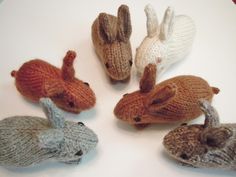 six knitted animals sitting on top of a white table next to eachother