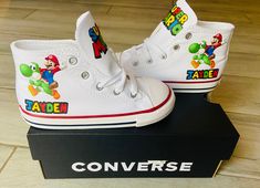 Mario custom converse can say any name you like and available In many colors. Each pair sold separately. Converse Mushroom, Bling Converse, Toddler Converse, Baby Bling, Custom Converse, Super Mario World, Mario Brothers, Converse High Top Sneaker, Converse Chuck Taylor High Top Sneaker